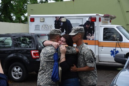 Former students distribute food and water at their local high school