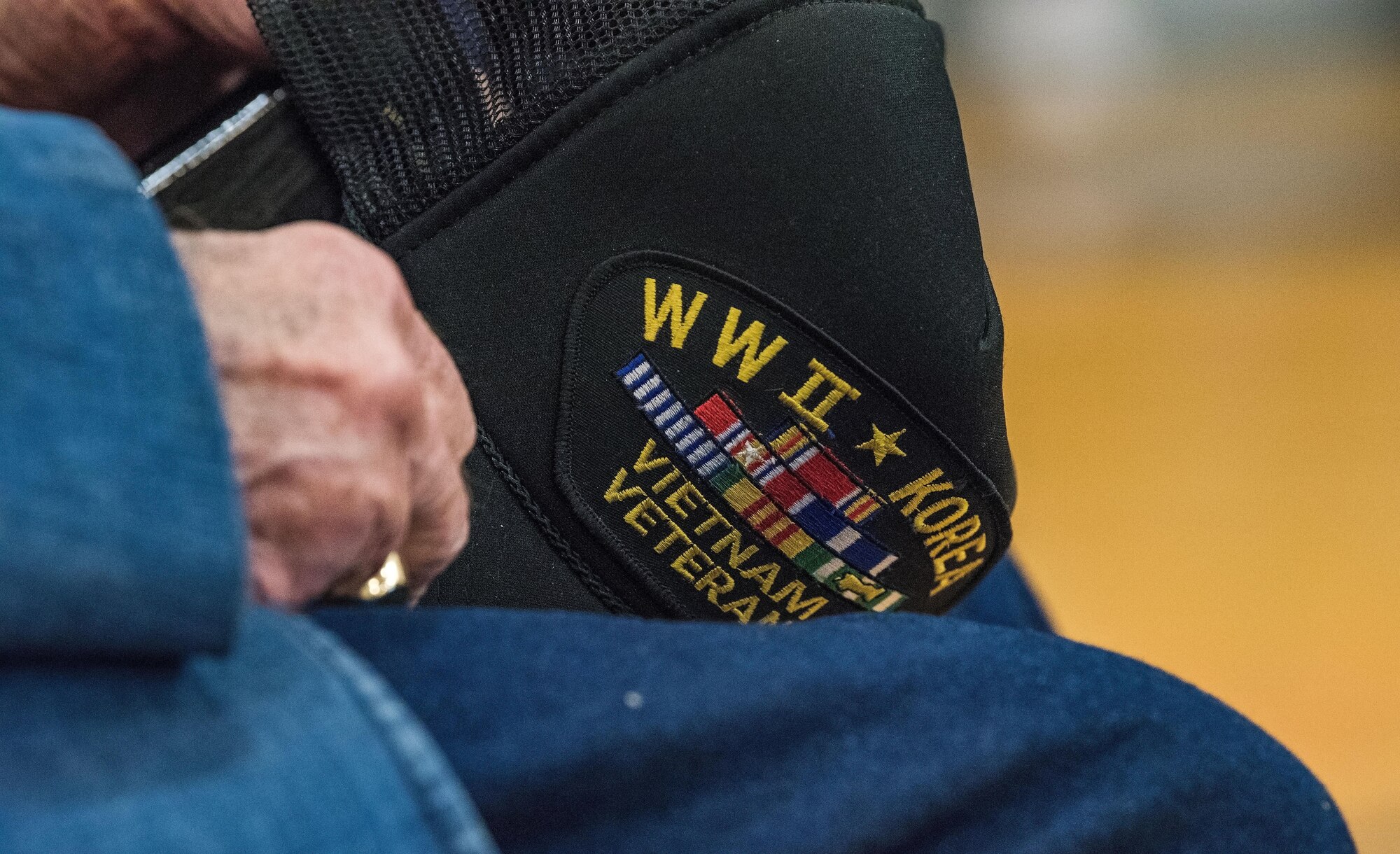 Retired Lt. Col. Clarence Wolgemuth, holds onto his cap during the Veterans Day ceremony where he was recognized for his military service Nov. 9, 2017, at Dover AFB Middle School on Dover AFB, Del. Wolgemuth was stationed at Dover AFB from 1956 to 1964. (U.S. Air Force photo by Roland Balik)