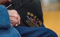 Retired Lt. Col. Clarence Wolgemuth, holds onto his cap during the Veterans Day ceremony where he was recognized for his military service Nov. 9, 2017, at Dover AFB Middle School on Dover AFB, Del. Wolgemuth was stationed at Dover AFB from 1956 to 1964. (U.S. Air Force photo by Roland Balik)