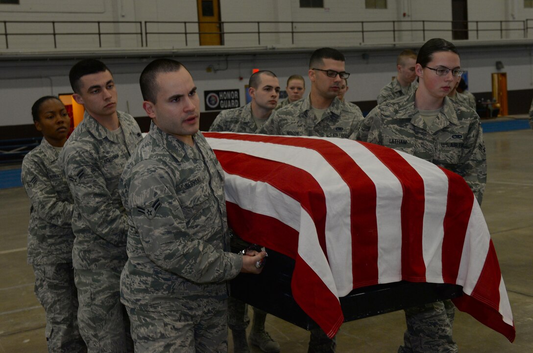 Airmen assigned to the Ellsworth Air Force Base, S.D., Honor Guard, carry a casket during a training exercise in the United States Air Force Honor Guard Mobile Training Team event at the Pride Hangar on base, Oct. 26, 2017. The honor guard flight underwent a week-and-a-half long course in basic protocol, honors and ceremonies. (U.S. Air Force photo by Airman Nicolas Z. Erwin)