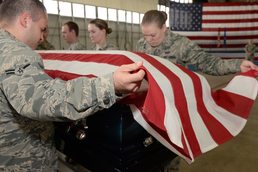 Airmen with the Ellsworth Air Force Base, S.D., Honor Guard lower a casket during a training exercise at the Pride Hangar on base, Oct. 26, 2017. There are three primary retiree sequences: a casket, cremation or vault, each which require different movements and coordination to do properly. (U.S. Air Force photo by Airman Nicolas Z. Erwin)