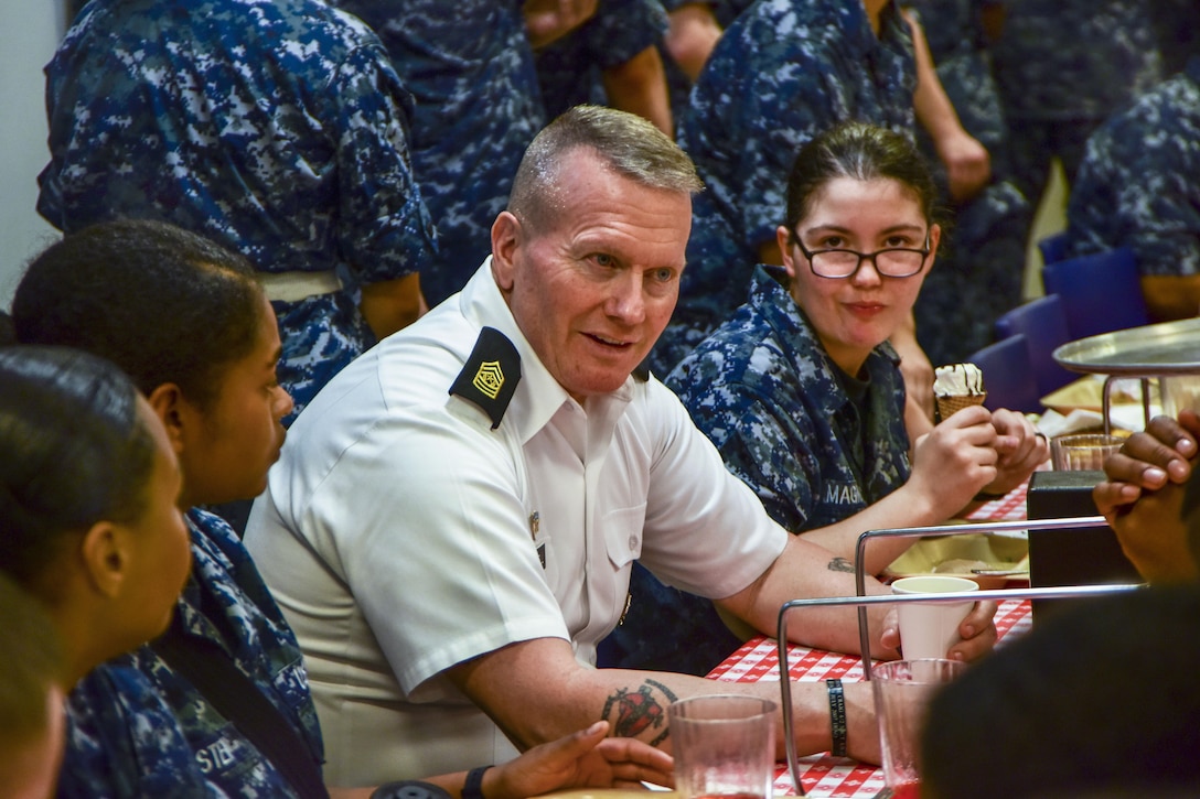 The senior enlisted advisor to the Chairman of the Joint Chiefs of Staff dines with sailors.