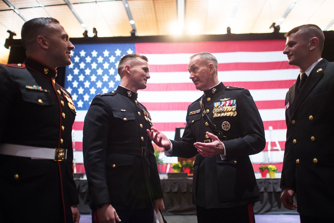 Marine Corps Gen. Joe Dunford speaks to three Marines.