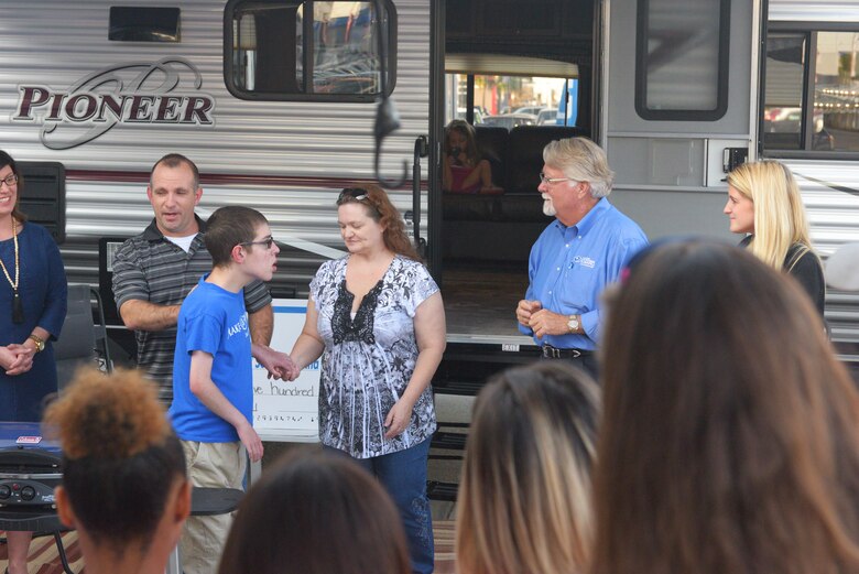 Capt. Steven Braddick, Weapons Station Engineering Element Chief with the 628th Air Base Wing Civil Engineer Squadron, his wife Renee Braddick, and their son Nathan James Braddick, are presented with a new camper trailer as part of a Make-A-Wish event in Charleston, S.C. on November 7, 2017. The event was hosted by the Subaru of Charleston dealership. Nathan was nominated to receive the Make-A-Wish donation by members of the Hands of Hope Organization.