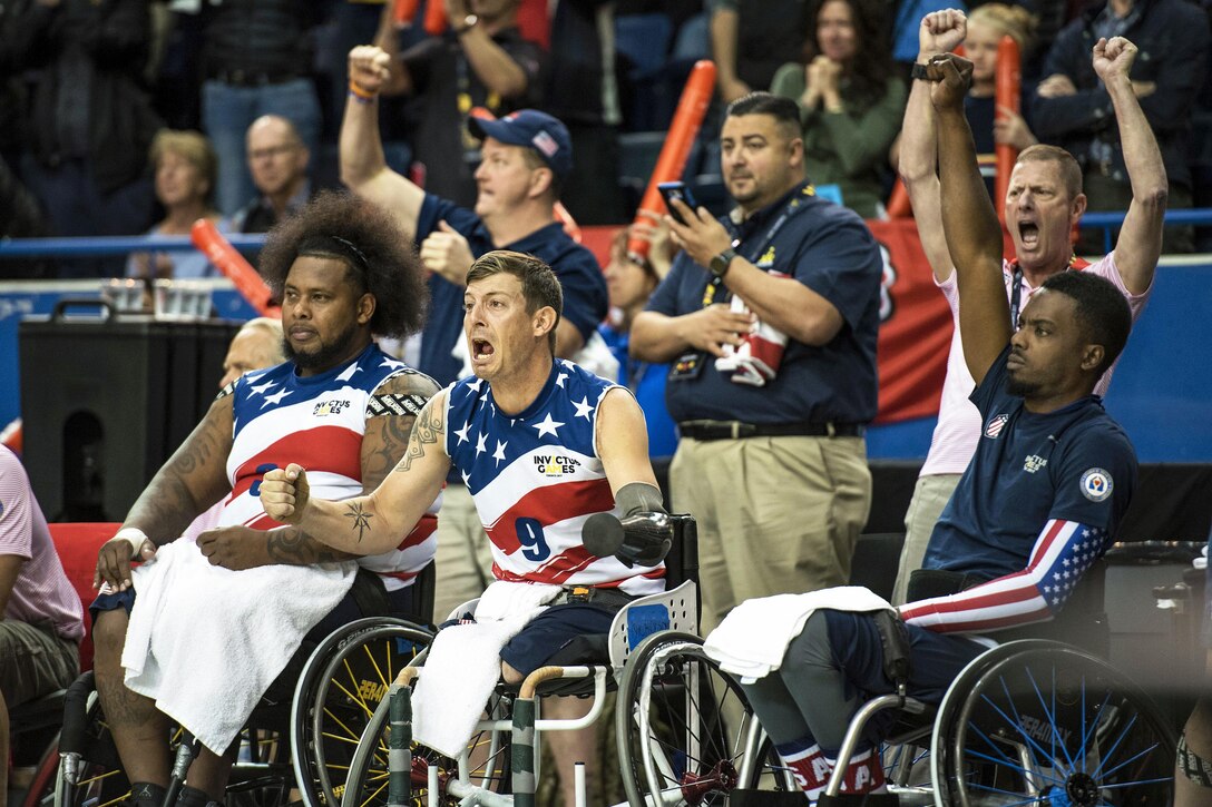 Members of U.S. Team show approval as their team wins.
