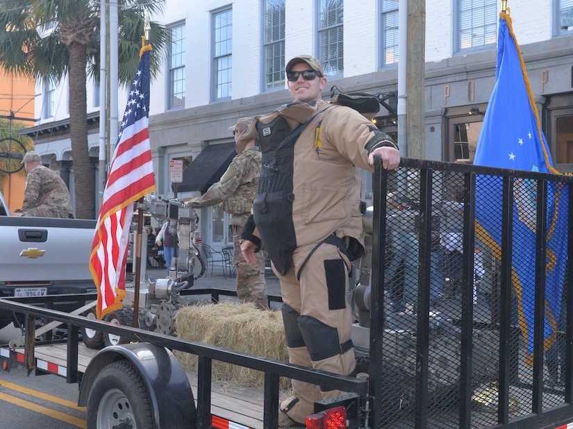 Explosive ordnance disposal airmen with JB Charleston’s 628th Civil Engineer Squadron, participate in downtown Charleston’s annual Veteran’s Day parade on November 11, 2017. The unit rode on a custom float displaying their REMOTEC Andros F6A Robot and signature bomb suit.