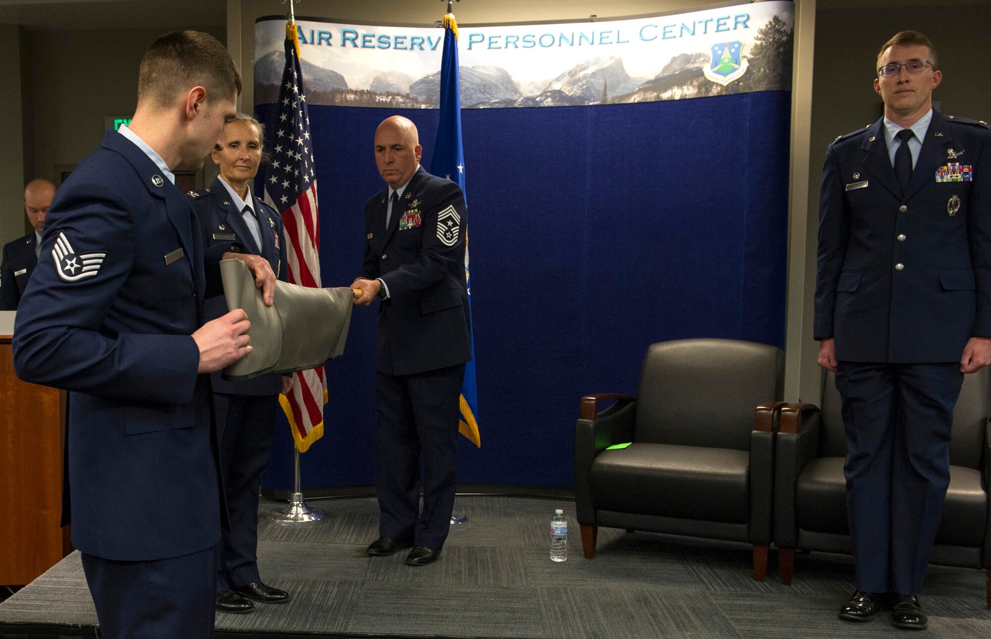 Col. Traci Kueker-Murphy, 310th Space Wing commander, prepares to unfurl the 710th Operations Group flag during the group's activation ceremony at Buckley AFB on Saturday, Nov. 4, 2017.