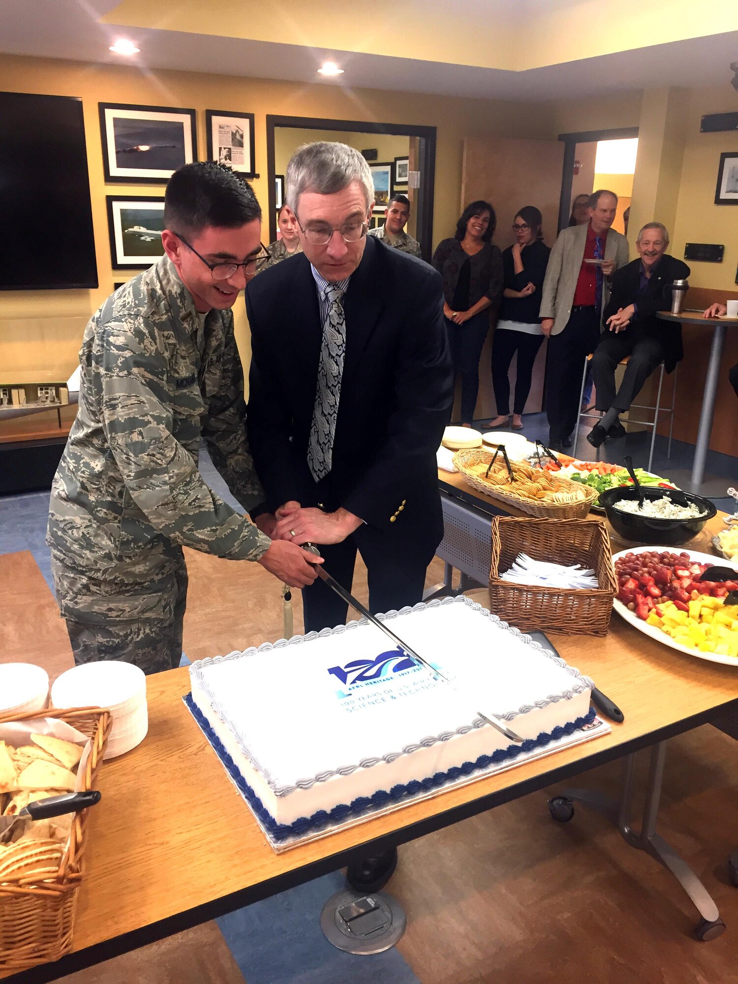 1st Lt. Steven McNamara (left) and Maj. Gen. (ret.) William Neil McCasland (ret.), cut the cake celebrating 100 years of heritage for the Air Force Research Laboratory Nov. 6 at the Heritage Annex.