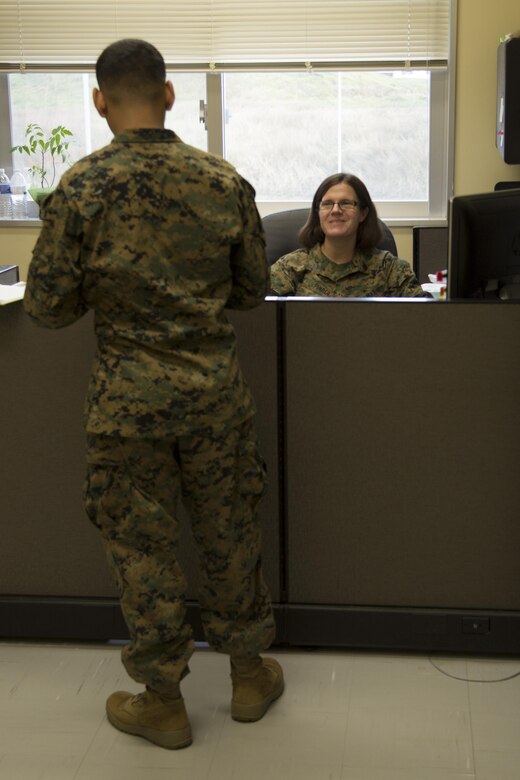CAMP FOSTER, OKINAWA, Japan – Staff Sgt. Julianna Pinder talks to a Marine in the Headquarters and Support Battalion Family Readiness Office Nov. 6 aboard Camp Foster, Okinawa, Japan.