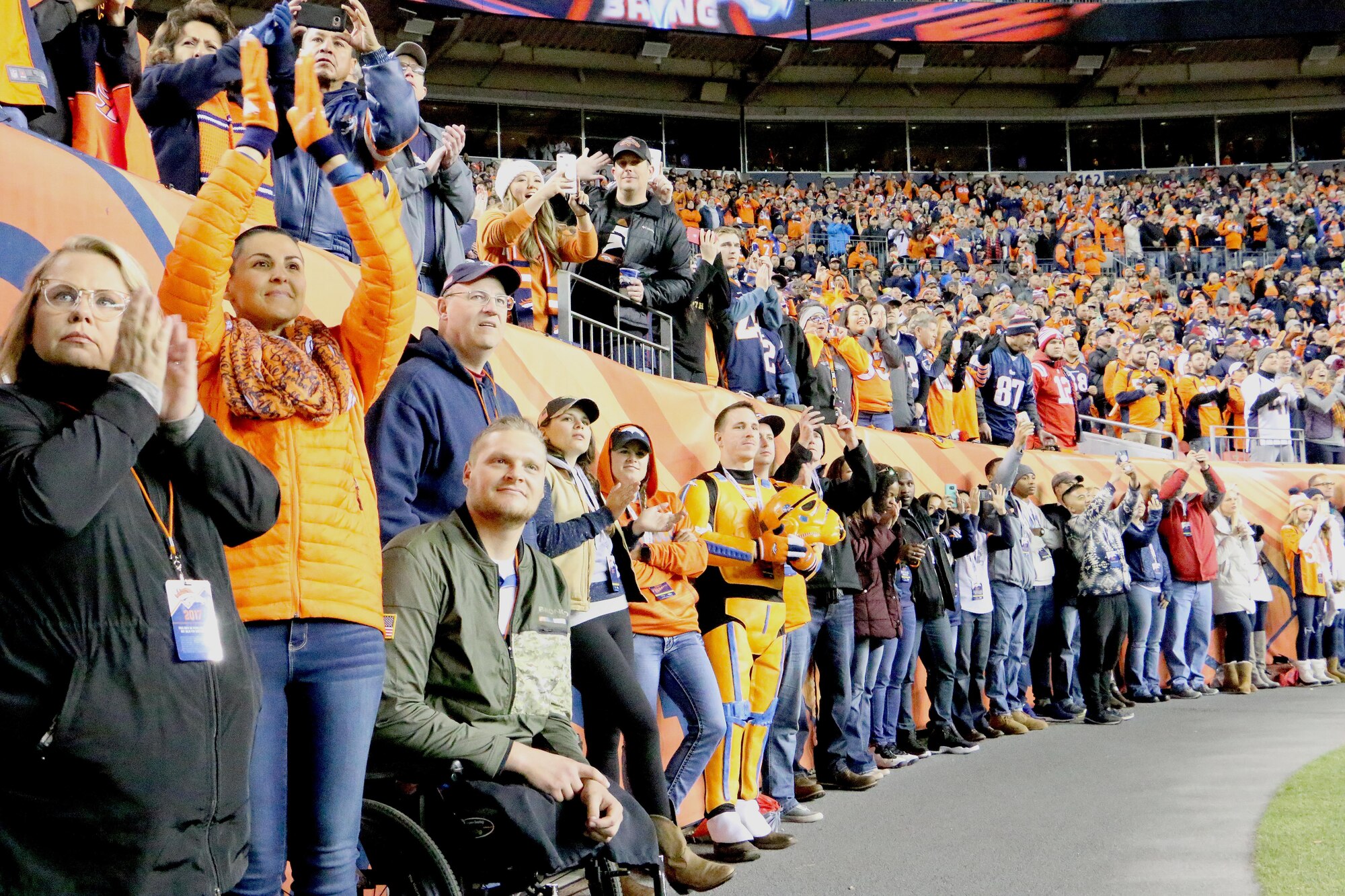 Peterson Airmen cheer from the sidelines at the Denver Bronco’s Sports Authority Field at the Mile High during the Salute to Service Game Nov. 12, 2017. Forty Peterson Airmen attended the game in honor of military service for Veteran’s Day. (U.S. Air Force photo by Staff Sgt. Erica Picariello)