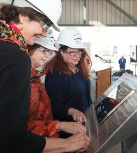 Ship’s Sponsors (left to right) Virginia Munford, Louisa Dixon and Pickett Wilson trace their initials onto a steel plate that will be welded inside the guided missile destroyer Lenah H. Sutcliffe Higbee (DDG 123).