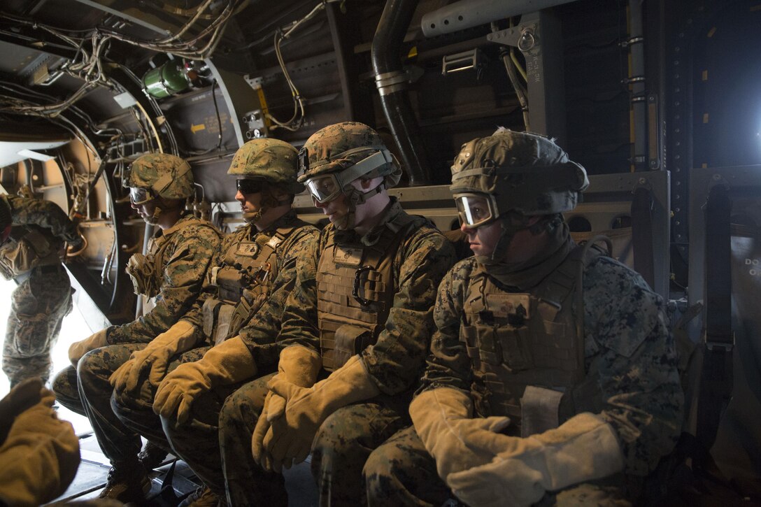 Marines wait to fast rope out of an MV-22 Osprey during Fast Rope Masters Course 18-1 at Camp Lejeune, N.C., Nov. 9, 2017. Marines learned how to assist each other in descending a fast rope out of various types of aircraft. Fast roping is a useful way of inserting into an area of operation when landing an aircraft is not an option. (U.S. Marine Corps photo by Cpl. Victoria Ross)