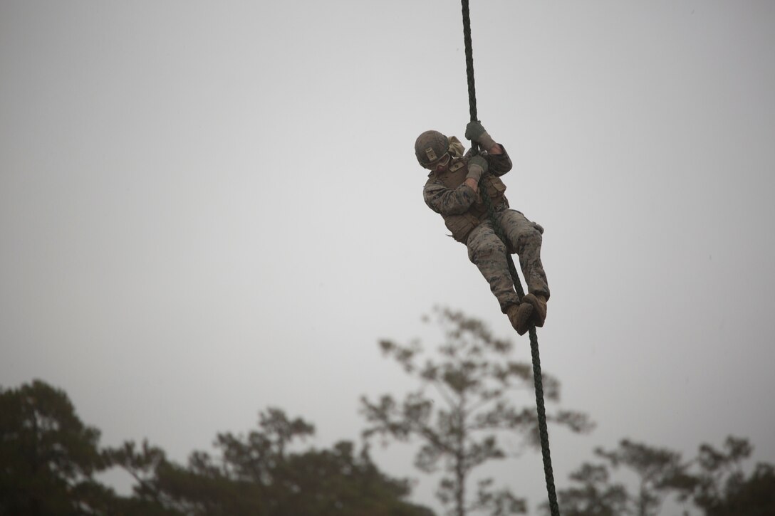 Cpl. Richard Myer, a squad leader with 2nd Battalion, 6th Marine Regiment, fast ropes out of an MV-22 Osprey during Fast Rope Masters Course 18-1 at Camp Lejeune, N.C., Nov. 9 2017.  Marines fast roped out of various helicopters day and night. The course requires Marines to be proficient at fast roping and helping other Marines fast rope out of various aircraft. (U.S. Marine Corps photo by Cpl. Victoria Ross)
