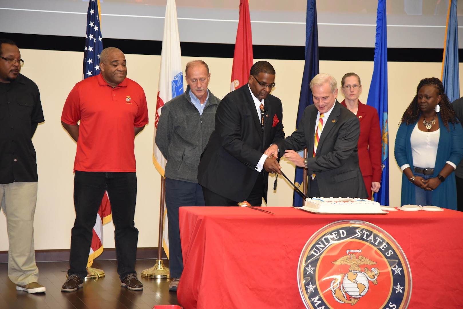 Paul Smith (left), DLA Distribution Current Operations and DLA Distribution chief of staff, Perry Knight (right) cut the cake during the 242nd Marine Corps birthday event held on Nov. 9, at DLA Distribution Headquarters in New Cumberland, Pennsylvania.