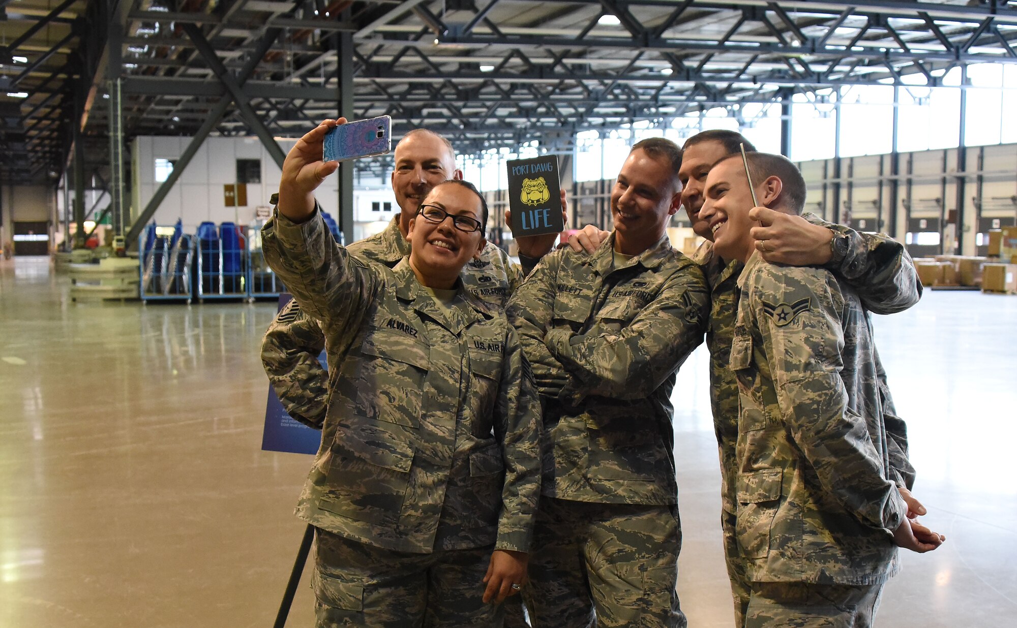 Maj. Gen. Christopher Bence, commander, USAF Expeditionary Center and Command Chief Master Sgt. Larry Williams, USAF EC command chief, pause to take a 'selfie' while visiting Airmen assigned to the 721st Aerial Port Squadron at Ramstein Air Base, Germany, Nov. 4, 2017. Bence and Williams along with the 521st Air Mobility Operations Wing leadership team visited six squadrons of the 521st AMOW at Ramstein AB and Spangdahlem AB, Germany, Aviano AB, Italy and RAF Mildenhall, U.K. (U.S. Air Force photo by Tech. Sgt. Jamie Powell)