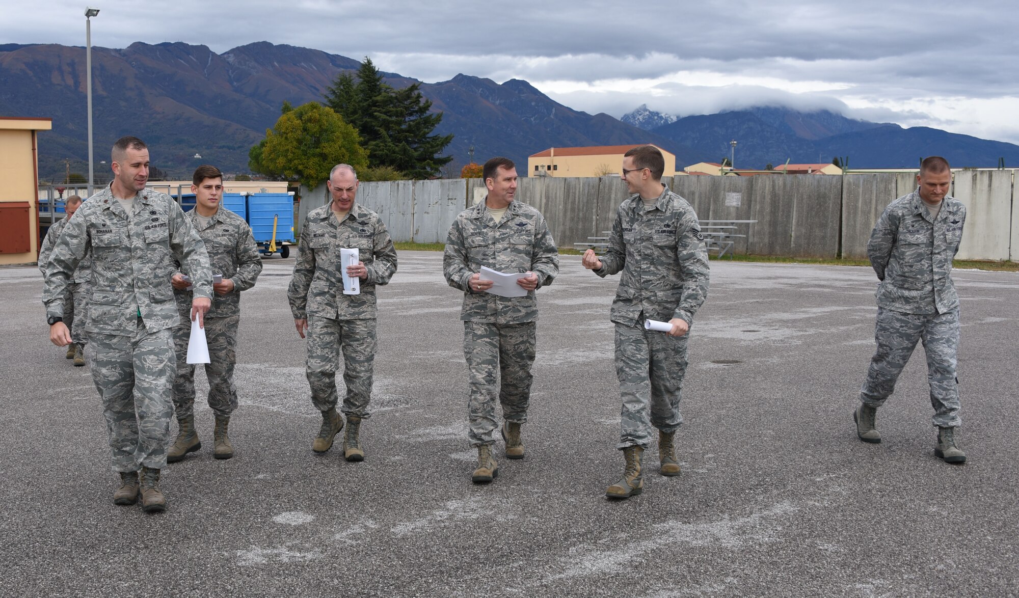 Staff Sgt. Nicholas Cochran (center right), with the 724th Air Mobility Squadron, briefs Maj. gen. Christopher Bence (center), commander, USAF Expeditionary Center and Command Chief Master Sgt. Larry Williams, USAF EC command chief, on the facility upgrade plans for the 724th AMS at Aviano Air Base, Italy, Nov. 6, 2017. Bence and Williams along with the 521st Air Mobility Operations Wing leadership team visited six squadrons of the 521st AMOW at Ramstein AB and Spangdahlem AB, Germany, Aviano AB, Italy and RAF Mildenhall, U.K. (U.S. Air Force photo by Tech. Sgt. Jamie Powell)