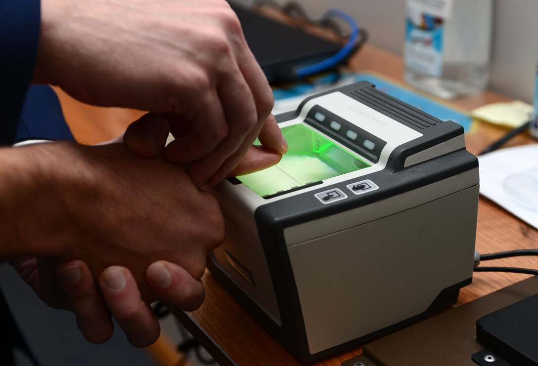 Michael Horn, a Special Agent assigned to Detachment 816, conducts a fingerprint scan in the Taub Building on Ellsworth Air Force Base, S.D., Nov. 3, 2017. AFOSI has many tools at their disposal to aid in accomplishing RIC: recovery, indictments and convictions. (U.S. Air Force photo by Airman 1st Class Donald C. Knechtel)