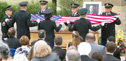 Soldiers from the Military Funeral Honors Caisson Detachment prepare to drape the American flag over the casket bearing the remains of retired Gen. Richard H. Cavazos during Caisson Funeral Honors (Fallen Stars) for Cavazos at the Fort Sam Houston National Cemetery Nov. 14.