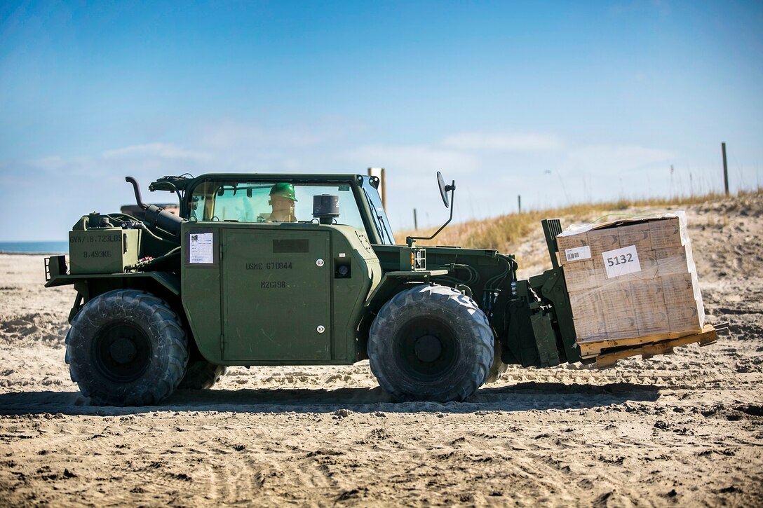 A Marine uses a heavy forklift to transports supplies during Composite Training Unit Exercise.