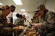 Col. Jennifer Short, 23d Wing commander, right, serves food to Airmen during the Annual Airmen’s Thanksgiving luncheon, Nov. 14, 2017, at Moody Air Force Base, Ga. Moody Chiefs Group, with the support of various base organizations, held the luncheon because many Airmen are unable to return home for Thanksgiving. (U.S. Air Force photo by Airman 1st Class Erick Requadt)