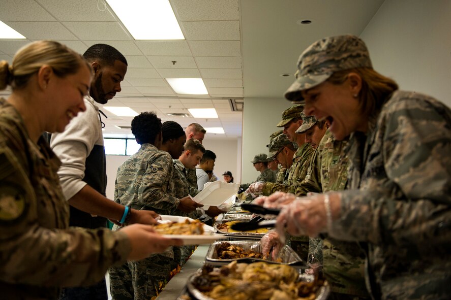 Col. Jennifer Short, 23d Wing commander, right, serves food to Airmen during the Annual Airmen’s Thanksgiving luncheon, Nov. 14, 2017, at Moody Air Force Base, Ga. Moody Chiefs Group, with the support of various base organizations, held the luncheon because many Airmen are unable to return home for Thanksgiving. (U.S. Air Force photo by Airman 1st Class Erick Requadt)