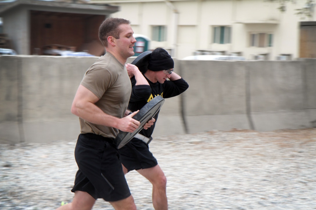 Soldiers run with 25 pound weights during Marne Week.