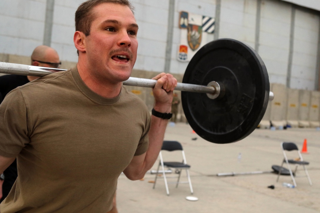 A service member completes in a squat exercise on Bagram Airfield.