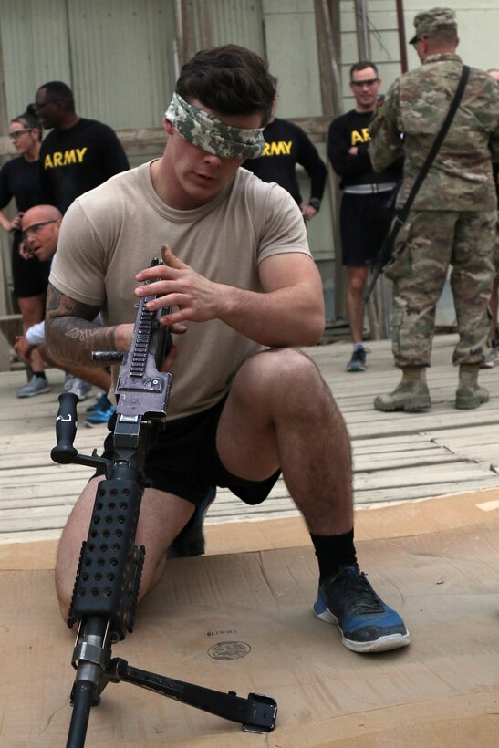 A service member assembles a machine gun blindfolded.