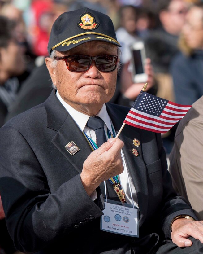 Korean War veteran waves American Flag