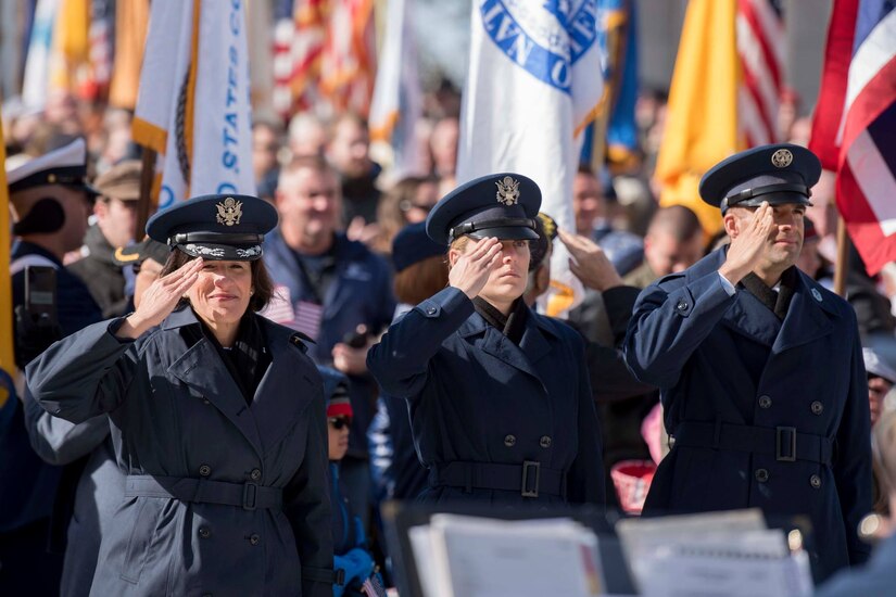 Air Force members salute the American Flag