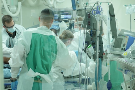 A Brooke Army Medical Center trauma team examines a patient in the emergency department. BAMC received its level I trauma center recertification from the American College of Surgeons.