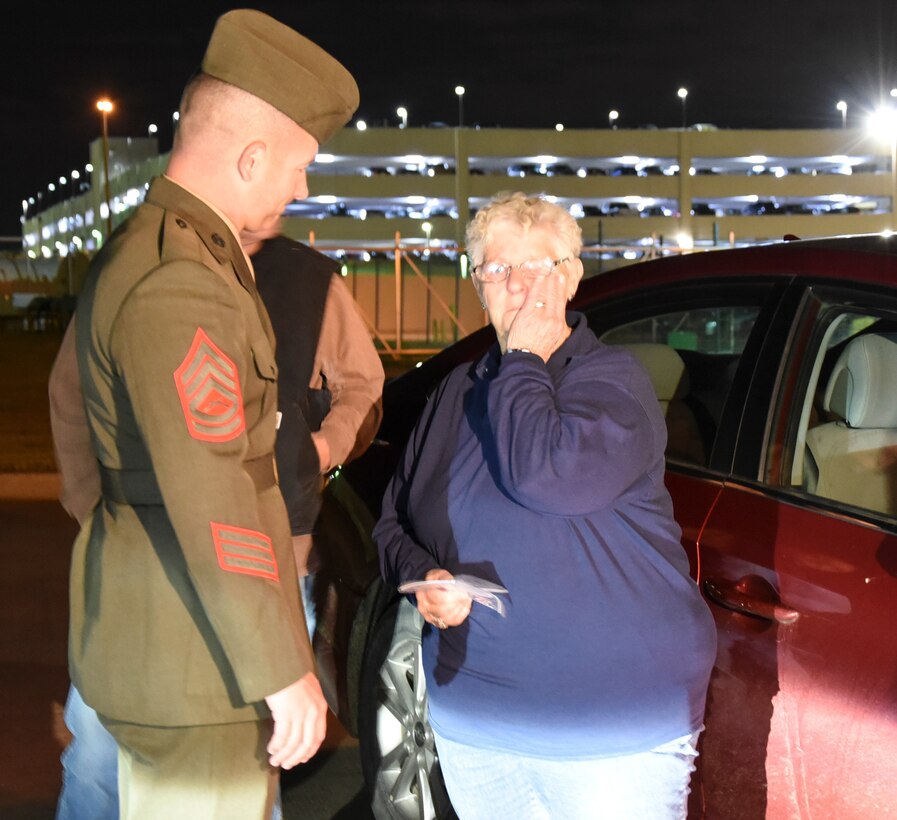 Sandra Lewis, the niece of Marine Corps Pvt. Vernon Paul Keaton wipes tears away after speaking with Gunnery Sgt. Nicholas Brundige, Assistant Marine Corps funeral director, Marine Headquarters Barracks, Washington, D.C., speaks with , in a secluded section of Will Rogers World Airport November 14, 2017, Oklahoma City, Oklahoma.