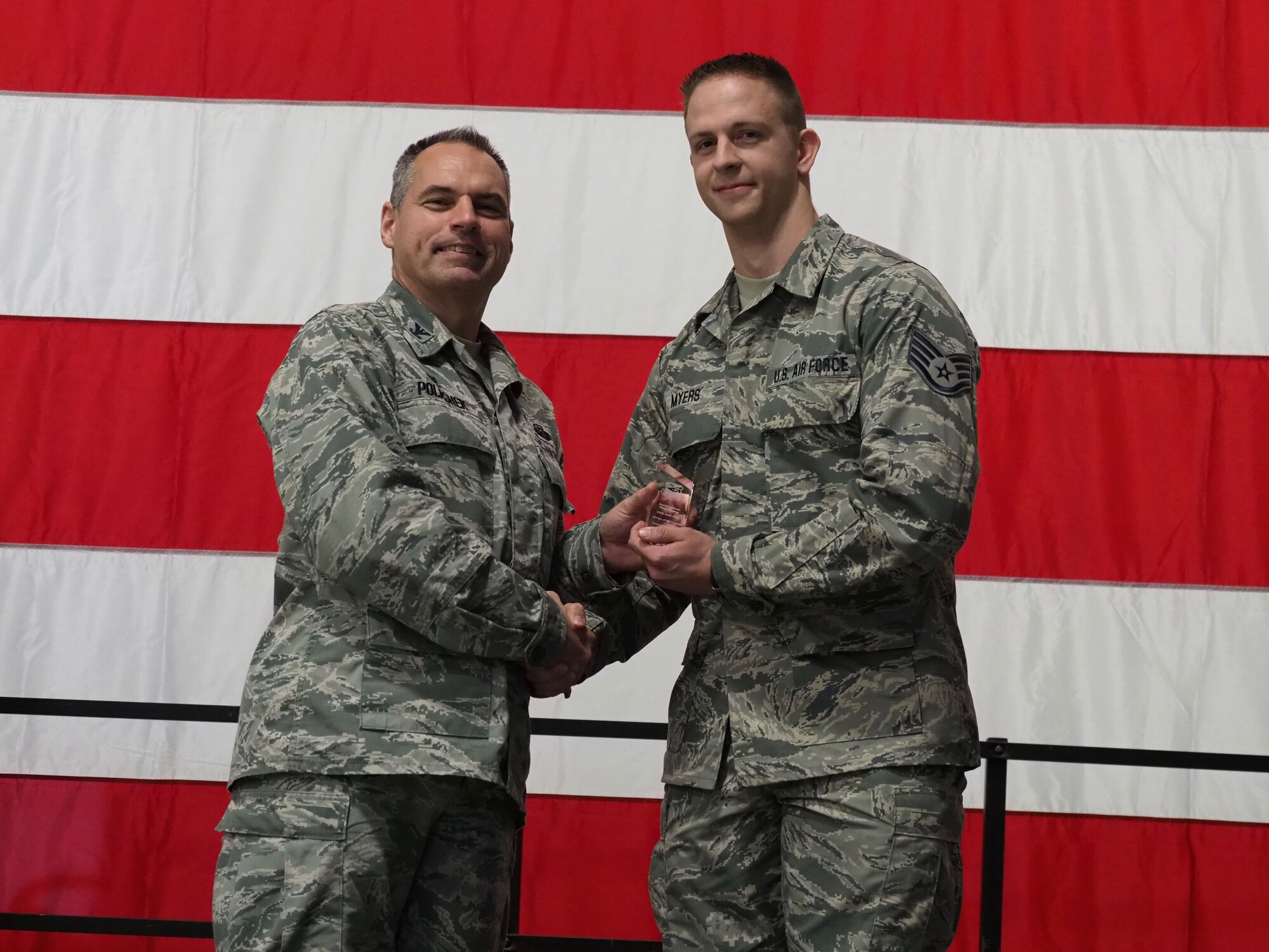 Staff Sgt. Riley Myers is recognized as the Airmen of the Quarter by Col. Tony Polashek, 934th Airlift Wing commander, at the Wing Commander's Call Nov. 4. (Air Force Photo/Paul Zadach)