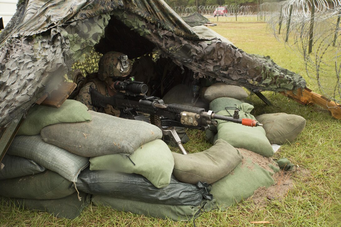 Lance Cpl. Hunter Gross, 4th platoon, Charlie Co., Fleet Anti-terrorism Security Team, U.S. Marine Corps Security Forces Regiment, maintains a fighting position during a diplomatic security and embassy reinforcement training exercise at Joint Expeditionary Base Ft. Story, Virginia Beach, Va., Nov. 8. FAST Marines used a vacant U.S. Army barracks to set up a checkpoint to simulate a notional U.S. Embassy in Kiev, Ukraine. (Official U.S. Marine Corps photo by Chris Jones/Released)
