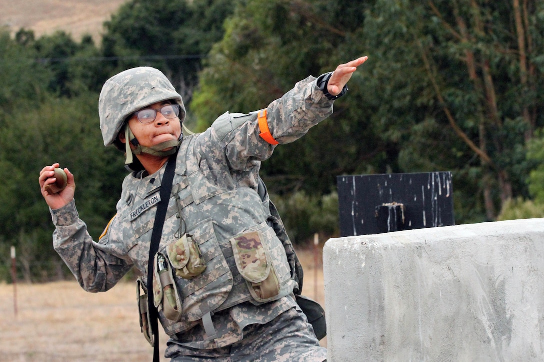 Army Spc. Emefa Freckleton prepares to throw a grenade simulator.