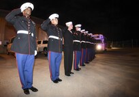 1st Sgt. Kerwin Williams, Marine Corps Honor Guard team leader, left, leads a mixed formation of Marines and a lone sailor in saluting as the remains of Marine Corps Pvt. Vernon Paul Keaton leave the Will Rogers World Airport, Oklahoma City, Oklahoma, Nov. 14, 2017.