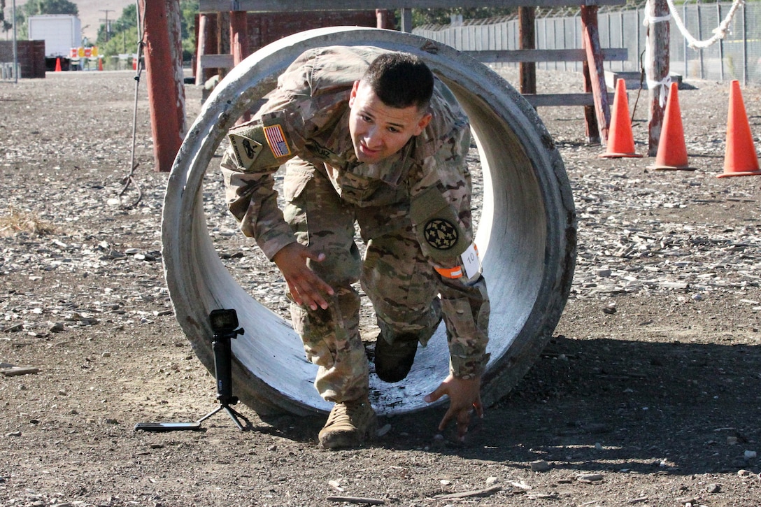 Army Sgt. George Ruiz exits a tunnel obstacle.