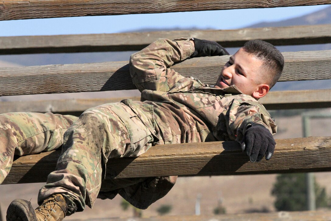 Army Sgt. George Ruiz maneuvers his way through the weave obstacle.