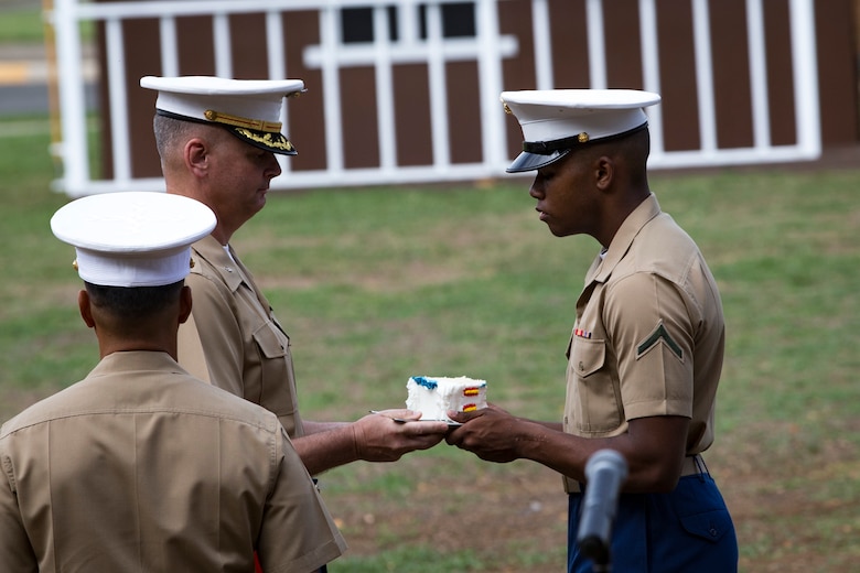 U.S. Marine Corps Lt. Col. Christopher J. Broadston, the oldest Marine present, passes the first piece of cake to PFC. Lawrence A. Sivils Jr., the youngest Marine present, as part of the annual Birthday Pageant aboard, Marine Corps Base Hawaii, Nov. 9, 2017. The birthday pageant celebrates the birthday of the Marine Corps and pays homage to the rich legacy of the Corps. (U.S. Marine Corps photo by Sgt. Alex Kouns/Released)