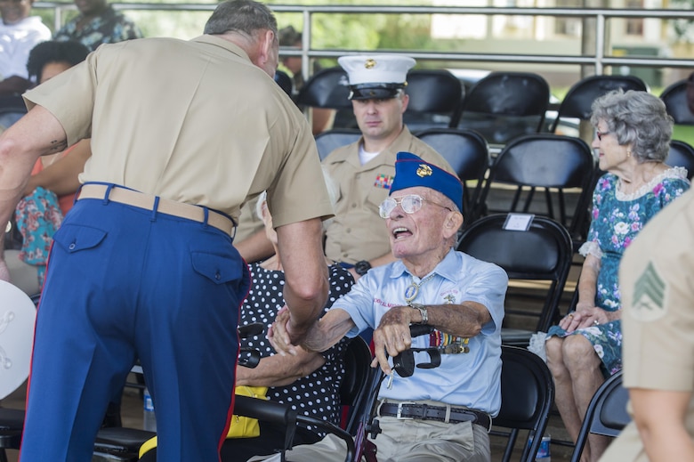 An active duty U.S. Marine shakes hands with retired Master Gunnery Sgt. Bob Talmage, a Korean War veteran, during the Marine Corps birthday pageant, Marine Corps Base Hawaii, Nov. 9, 2017. The birthday pageant celebrates the birthday of the Marine Corps and pays homage to the rich legacy of the Corps. (U.S. Marine Corps photo by Lance Cpl. Luke Kuennen)