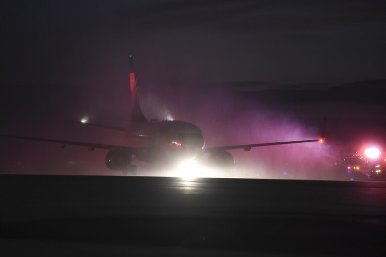 A Delta Airlines Boeing 737 carrying the remains of Marine Corps Pvt. Vernon Paul Keaton is sprayed with water in a symbolic water-cannon salute as the aircraft arrived November 14, 2017, Will Rogers World Airport, Oklahoma City, Oklahoma.