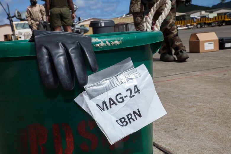 A bucket belonging to chemical, biological, radiological and nuclear (CBRN) section, Marine Aircraft Group  24, holds used gloves after a detailed aircraft decontamination (DECON) exercise, Marine Corps Base Hawaii, Nov. 8, 2017. The DECON exercise instructed Marines on proper techniques and procedures with responding to a CBRN contamination on a static helicopter. (U.S. Marine Corps photo by Cpl. Jesus Sepulveda Torres)