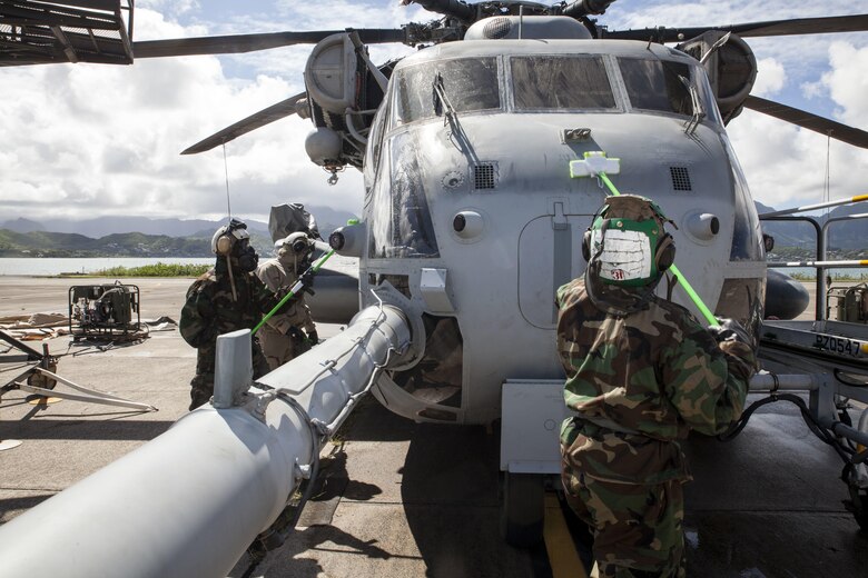 U.S. Marines with Marine Heavy Helicopter Squadron  463, also known as “Pegasus,” Marine Aircraft Group  24, scrub down the front of a CH-53E Super Stallion helicopter during  a detailed aircraft decontamination (DECON) exercise, Marine Corps Base Hawaii , Nov. 8, 2017. The DECON exercise instructed Marines on proper techniques and procedures with responding to a chemical, biological, radiological or nuclear contamination on a static helicopter. (U.S. Marine Corps photo by Cpl. Jesus Sepulveda Torres)