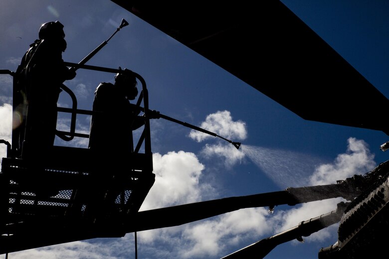 U.S. Marines with Marine Heavy Helicopter Squadron  463, also known as “Pegasus,” Marine Aircraft Group  24, use a step ladder to power wash rotors from a CH-53E Super Stallion helicopter during a detailed aircraft decontamination (DECON) exercise, Marine Corps Base Hawaii , Nov. 8, 2017. The DECON exercise instructed Marines on proper techniques and procedures with responding to a chemical, biological, radiological or nuclear contamination on a static helicopter. (U.S. Marine Corps photo by Cpl. Jesus Sepulveda Torres)
