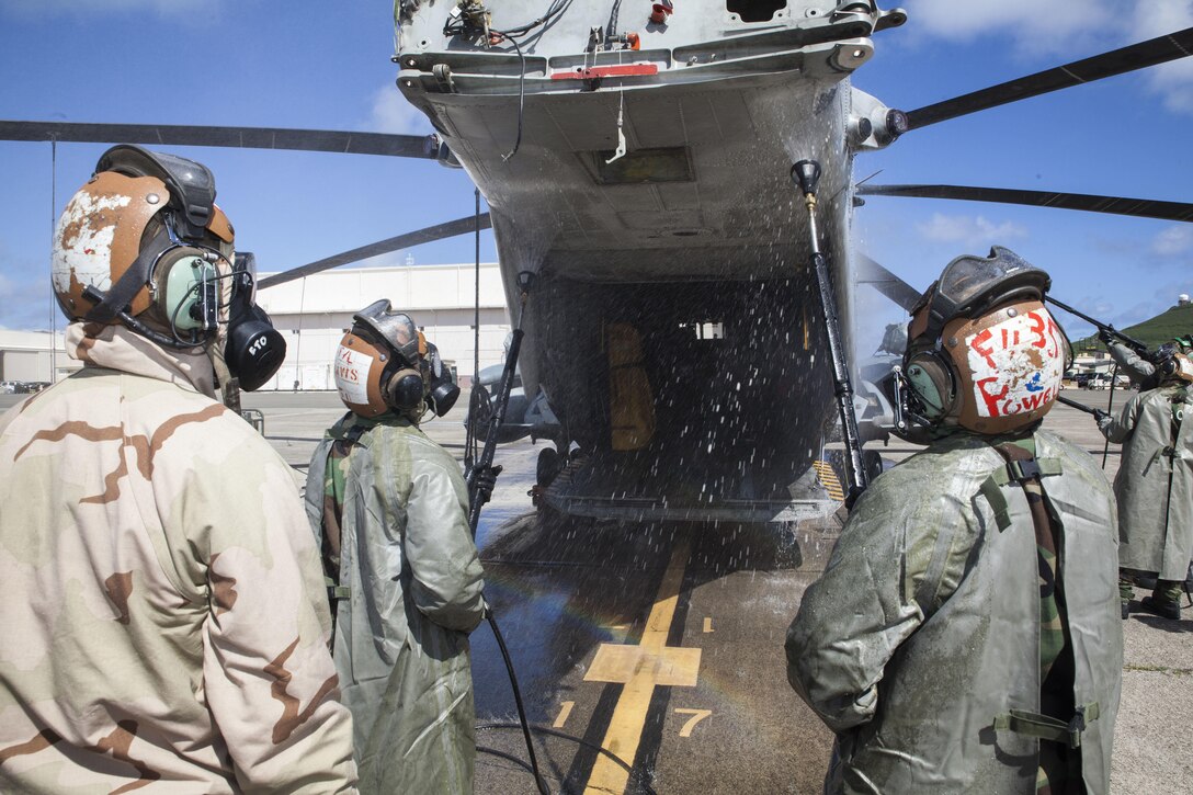 U.S. Marines with Marine Heavy Helicopter Squadron  463, also known as “Pegasus,” Marine Aircraft Group  24, hose down the rear end of a CH-53E Super Stallion helicopter during a detailed aircraft decontamination (DECON) exercise, Marine Corps Base Hawaii , Nov. 8, 2017. The DECON exercise instructed Marines on proper techniques and procedures with responding to a chemical, biological, radiological or nuclear contamination on a static helicopter. (U.S. Marine Corps photo by Cpl. Jesus Sepulveda Torres)