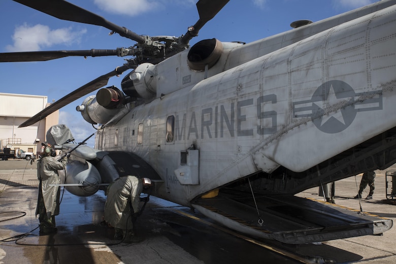 U.S. Marines with Marine Heavy Helicopter Squadron  463, also known as “Pegasus,” Marine Aircraft Group  24, begin power spraying a CH-53E Super Stallion helicopter during a detailed aircraft decontamination (DECON) exercise, Marine Corps Base Hawaii , Nov. 8, 2017. The DECON exercise instructed Marines on proper techniques and procedures with responding to a chemical, biological, radiological or nuclear contamination on a static helicopter. (U.S. Marine Corps photo by Cpl. Jesus Sepulveda Torres)