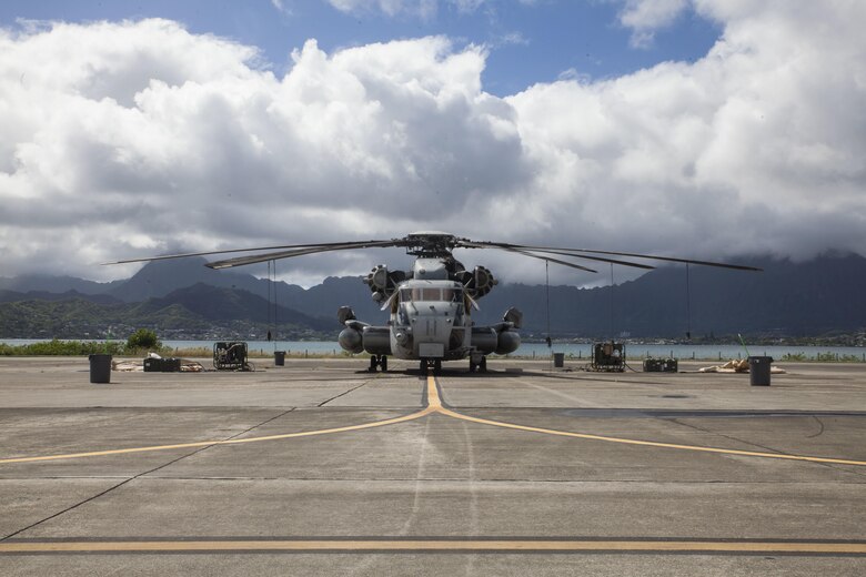 A CH-53E Super Stallion assigned to Marine Heavy Helicopter Squadron  463, also known as “Pegasus,” Marine Aircraft Group  24, is flanked by pumps and cleaning equipment prior to a detailed aircraft decontamination (DECON) exercise, Marine Corps Base Hawaii , Nov. 8, 2017. The DECON exercise instructed U.S. Marines with HMH-463 on proper techniques and procedures with responding to a chemical, biological, radiological or nuclear contamination on a static helicopter. (U.S. Marine Corps photo by Cpl. Jesus Sepulveda Torres)
