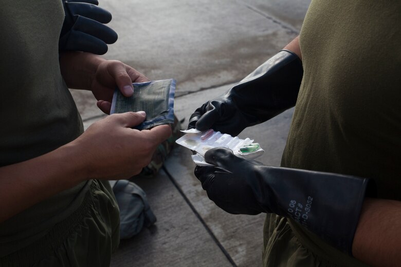 U.S. Marines with Marine Heavy Helicopter Squadron  463, also known as “Pegasus,” Marine Aircraft Group  24, prepare to use an M256A1 Chemical Agent Detector Kit prior to a detailed aircraft decontamination (DECON) exercise, Marine Corps Base Hawaii , Nov. 8, 2017. The DECON exercise instructed Marines on proper techniques and procedures with responding to a chemical, biological, radiological or nuclear contamination on a static helicopter. (U.S. Marine Corps photo by Cpl. Jesus Sepulveda Torres)