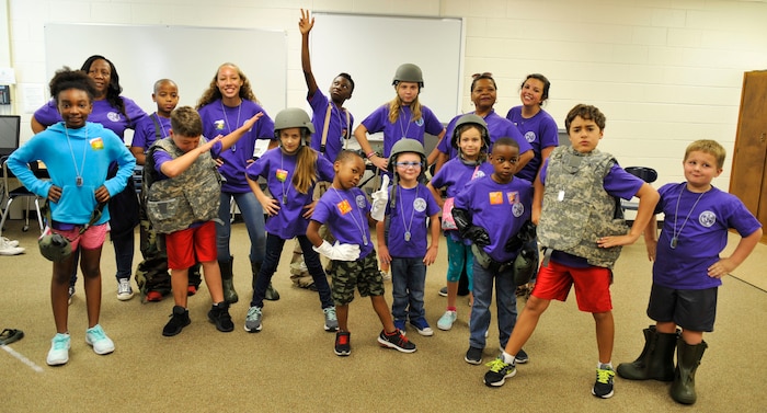 Volunteers and children participating in Operations Blue Waters, a youth deployment line, pose for a photo in their battle gear at Joint Base Charleston – Weapons Station, S.C., Nov. 4, 2017.