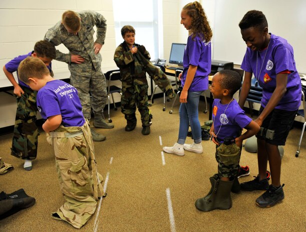 Children don mission-oriented protective posture gear during a youth deployment line at Joint Base Charleston – Weapons Station, S.C., Nov. 4, 2017.